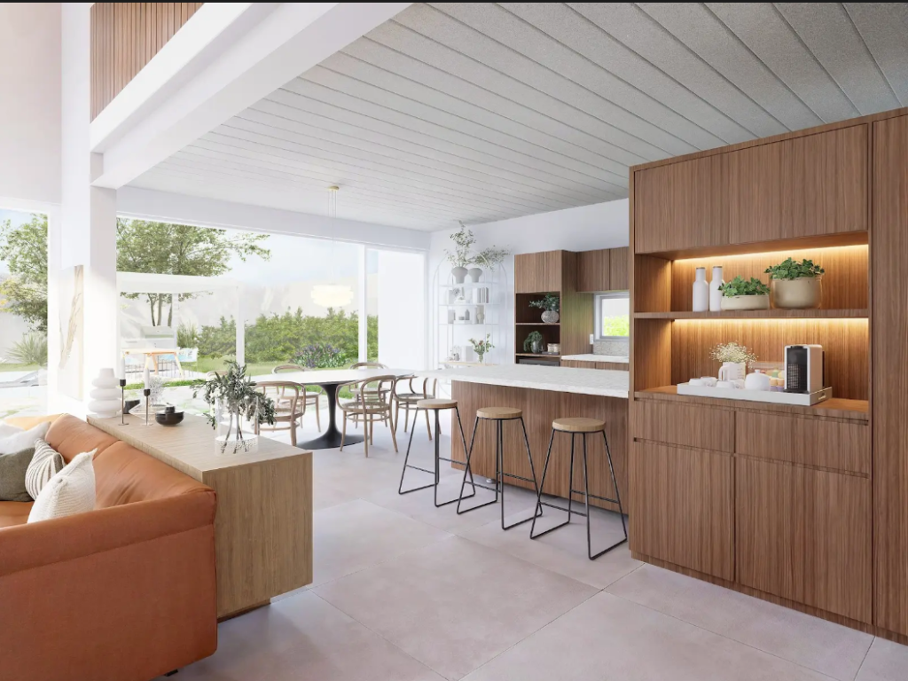 A imagem mostra a cozinha de uma casa em um ambiente em conceito aberto e iluminado por luz natural, com móveis de madeira e teto na cor branca. 